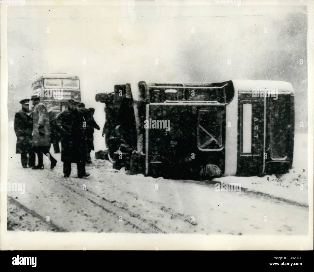 Jan. 01, 1954 - Snow and ice in 31 counties. Many escape as bus overturns near Southampton.: Roads in thirty-one counties of England and Wales were affected by snow or ice today in the cold spell which spread throughout the country. Road traffic was disrupted and trains delayed - and there were several accidents on treacherous roads. Forty five men on their way to an aircraft factory at Hursley, Hampshire, had lucky escapes when the works bus got out of control on a snowbound hill on the main Southampton - Winchester road. The bus toppled on to its side Stock Photo