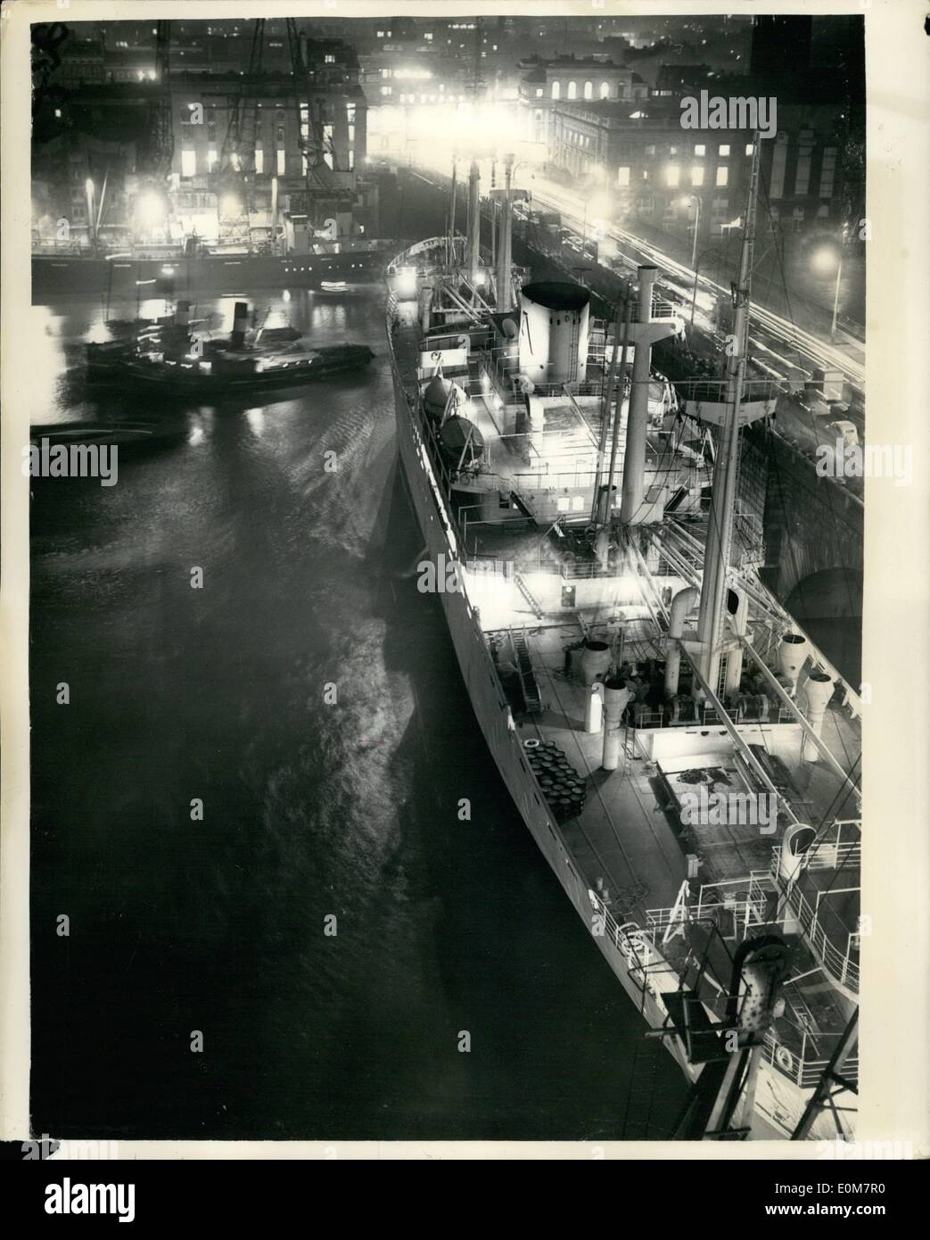 Jan. 01, 1954 - Spanish Cargo Vessel Rams London Bridge: Thousands of homeward bound City workers stopped on their way home this evening to each efforts to refloat the 487 feet Spanish cargo vessel ''Monte Uriquiola'' (7,723-tons) which jammed one of the South Bank buttresses of London Bridge as she was staring out on a 14 days round cruise to the Canary Islands. The ship was preparing to leave her berth and had cast off when the wind and the incoming tide slowed her round and brought her broadside against the bridge Stock Photo