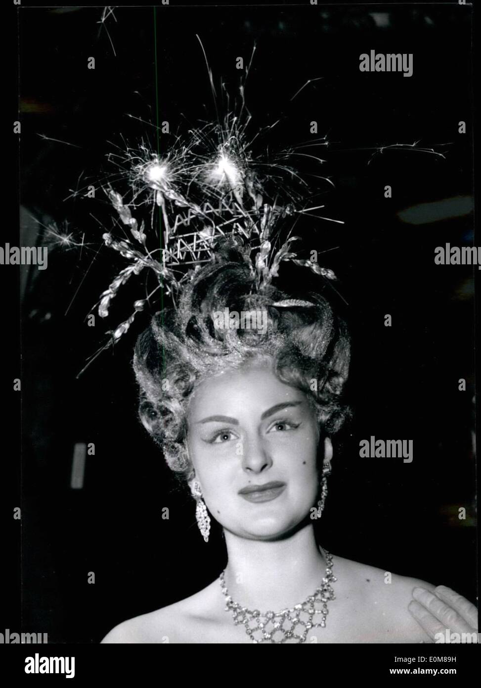 Dec. 12, 1953 - Fireworks for Hair dress: A charming Paris Mannequin displays the ''Latest'' in ''Explosive'' hair dresses: Fireworks to create a striking effect. This unusual novelty was introduced by a Paris Hairdresser at cocktail party held at Maxim's this afternoon. Stock Photo