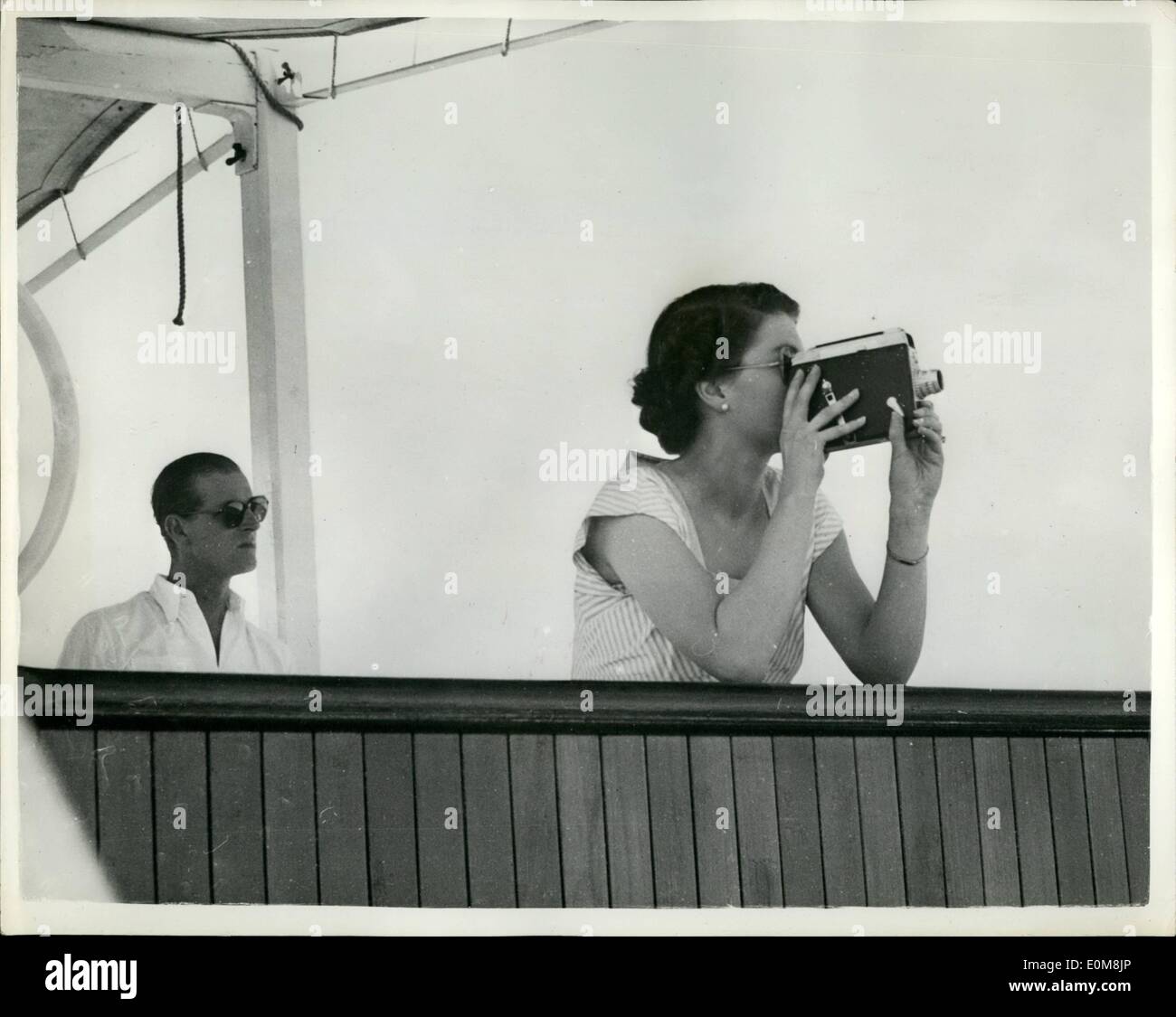 Dec. 12, 1953 - Royal Tour - Original picture.: The H.M.N.Z.S. Black Prince took over escorts duty to the royal tour liner ''Gothic'', in the Pacific, when H.M. The Queen and The Duke of Edinburgh were enroute for Suva. H.M. The Queen trains her cine camera on the New Zealand light cruiser Black Prince as the warship took over escort duty. Stock Photo