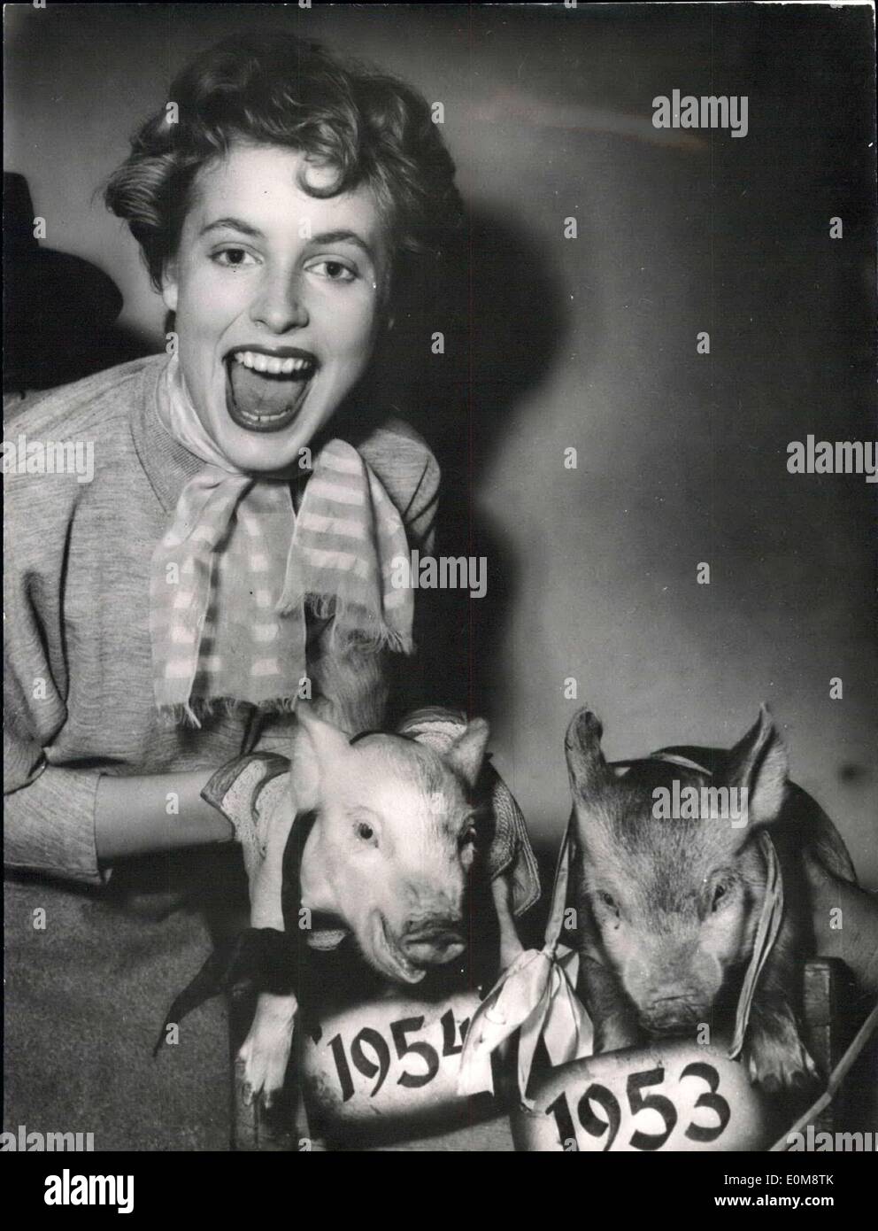 Dec. 21, 1953 - But the year 1954 is full of energy. The two little pigs are used as symbols for the now going and he new coming year. The starlett Anneliese Kaplan, who in 1953 had her first big part in the Carlton N film 'Meines Vaters Pferde' (The horses of my father) shows as the symbolized years. Stock Photo