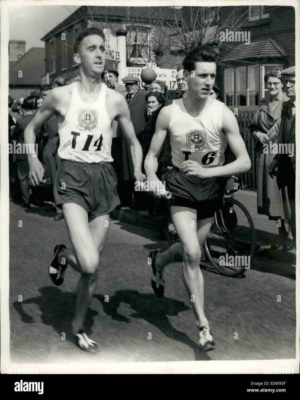 Apr. 04, 1954 - Gordon Pirie Takes Part In London-Brighton relay. Handing Over; The famous ''Puffing'' Gordon Pirie took part in the London to Brighton National Road Relay Race today when he ran in the seventh stage - from the White Lion, Lowfield Heath to the Red Lion Hotel, Handross - for the South London Harriers' team. Photo Shows Gordon Pirie hands over the baton to P.B. Driver at the Red Lion Hotel, Haderos during the event this afternoon. Stock Photo