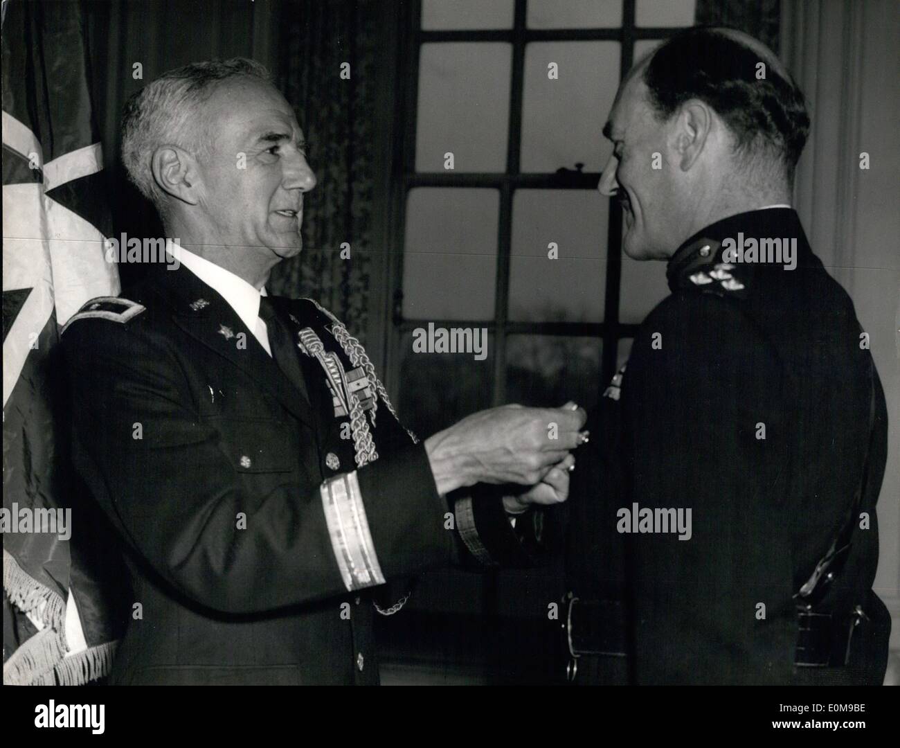 Mar. 03, 1954 - British Officer Honoured By Americans. Brigadierabdy H.G. Ricketts, CBF, DSO, Sachool of Land, Air Warfare, R.A.F. Station Old Sarum, Wilts, receives the Legion of Merit, Degree of Officer, From U.S. Army Attache General R.E.S. Williamson (left) during today;s Investiture, Mar 19, at London's Winfield House. Brigadier Ricketts was decorated for distinguished service as commander of the 29th Britsih infantry division in Korea. The citation praised his forseful leadership, keen discernment of the tactical situation, and able coordination of staff finctions. Stock Photo