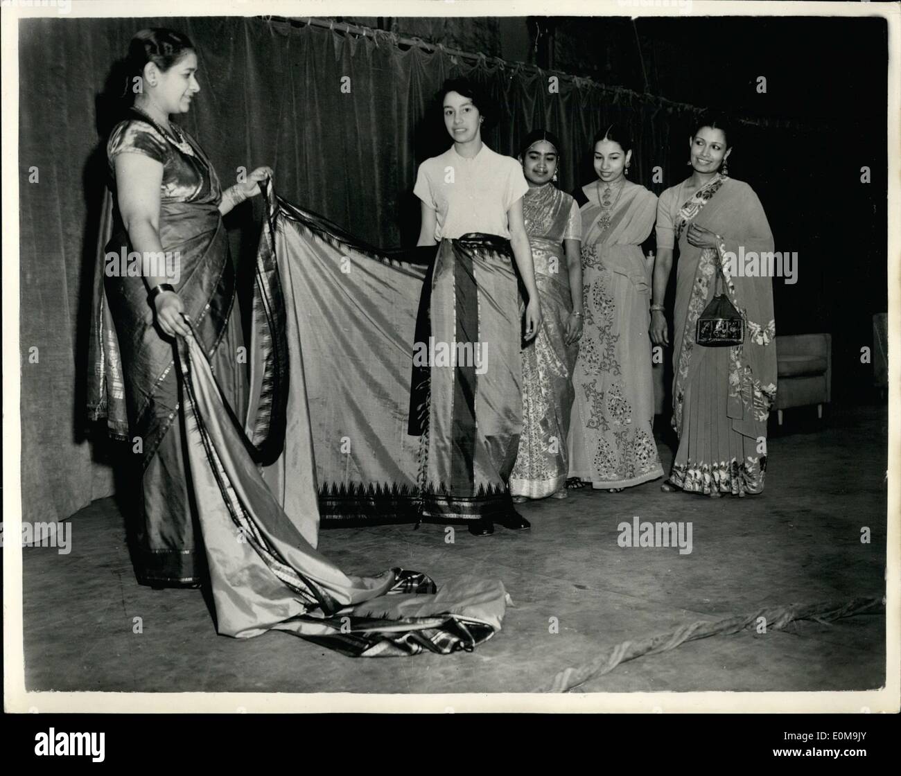 Apr. 04, 1954 - Women of Ceylon take part in TV programme: Today is Caylon's New Year Day, and members of the Association of the Women of Ceylon over here took part in the ''Leisure and Pleasure'' programme. Photo shows Mrs. Casinader demonstrates the length and fitting of a sari to TV viewers. Stock Photo