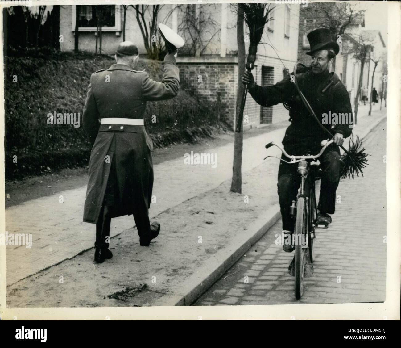 Mar. 03, 1954 - The Chimney Sweep Salutes With His Brush His Hat Is Otherwise Occupied: Police Supt. Ernst Werft, of Schleswig Holstein, Germany instructed his men to follow the Old Old custom of saluting good-luck sweep usually saluted in return but not with the traditional hat-raising..He held an inquiry - and discovered the reason to that the sweeps used their top hats as containers for eggs -- bacon - beer etc..give by grateful customers..So the sweeps continue to salute - with their brushes - and not hats Stock Photo