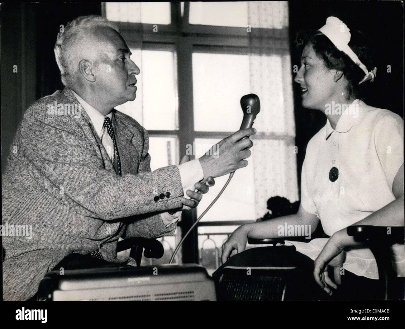 May 03, 1954 - Pictured is the grandson of the American railway magnate, Vanderbilt. Cornelius Vanderbilt Jr. doesn't consider being a millionaire a profession, so he travels the world with his film camera, tape recorder, and typewriter to capture stories. He is pictured here in Hamburg speaking with and recoding his chambermaid. Later he would travel on to Bremen, Duesseldorf, Koeln, Frankfurt, Wiesbaden, and Munich. Stock Photo