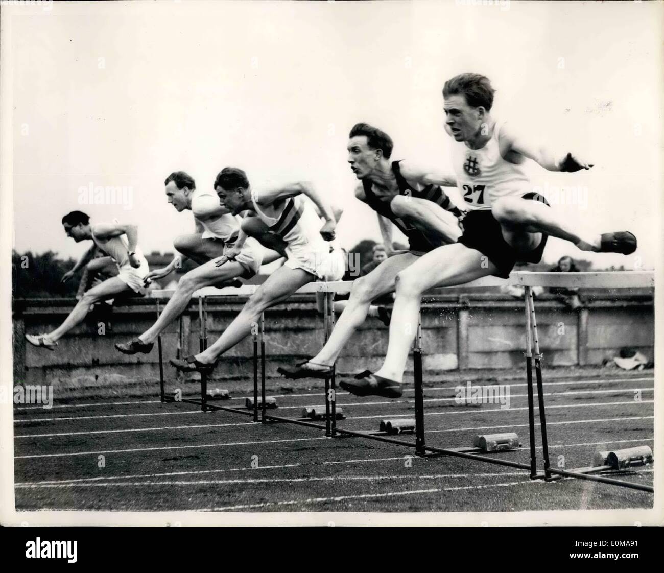 May 05, 1954 - Athletics at Chiswick.: The Athletic Meeting at Chiswick today consisted of the annual inter-club contest for the Sward Trophy organized by the Polytechnic Harriers, and some invitation races on the track. Photo shows taking the hurdle during Final of the 120 Yards Hurdles - Sward Trophy - are (L to R): P.B. Hildreth, the winner; J Bentley, P.A.I. Vine(3rd) and F.J. Parker. Stock Photo