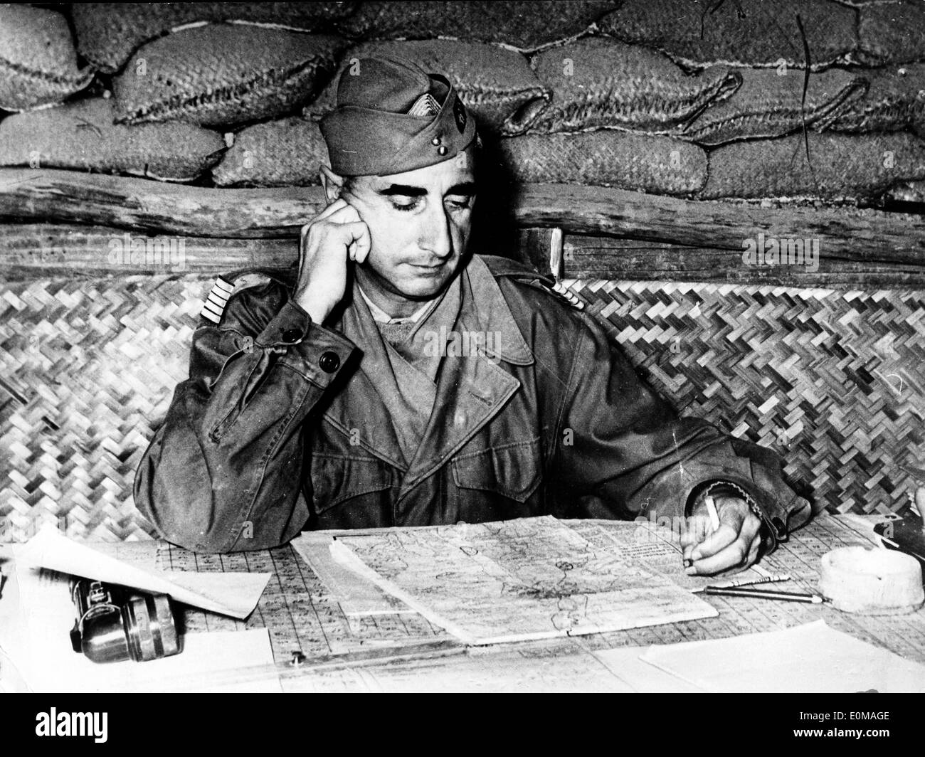 General De Castries in his headquarters reading a map Stock Photo