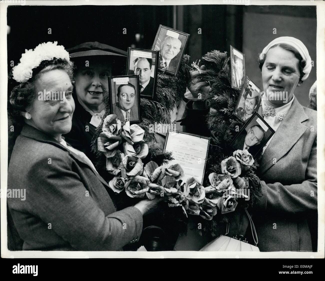 Jul. 02, 1954 - The end of rationing in Britain. Housewives as present the food ministry with a wreath! : With the taking of meat off the ration tomorrow - Saturday - Rationing ends in Britain after fourteen years - so that for the first time since 1940 housewives can purchase whatever they can afford - and the ration books can be burned Stock Photo