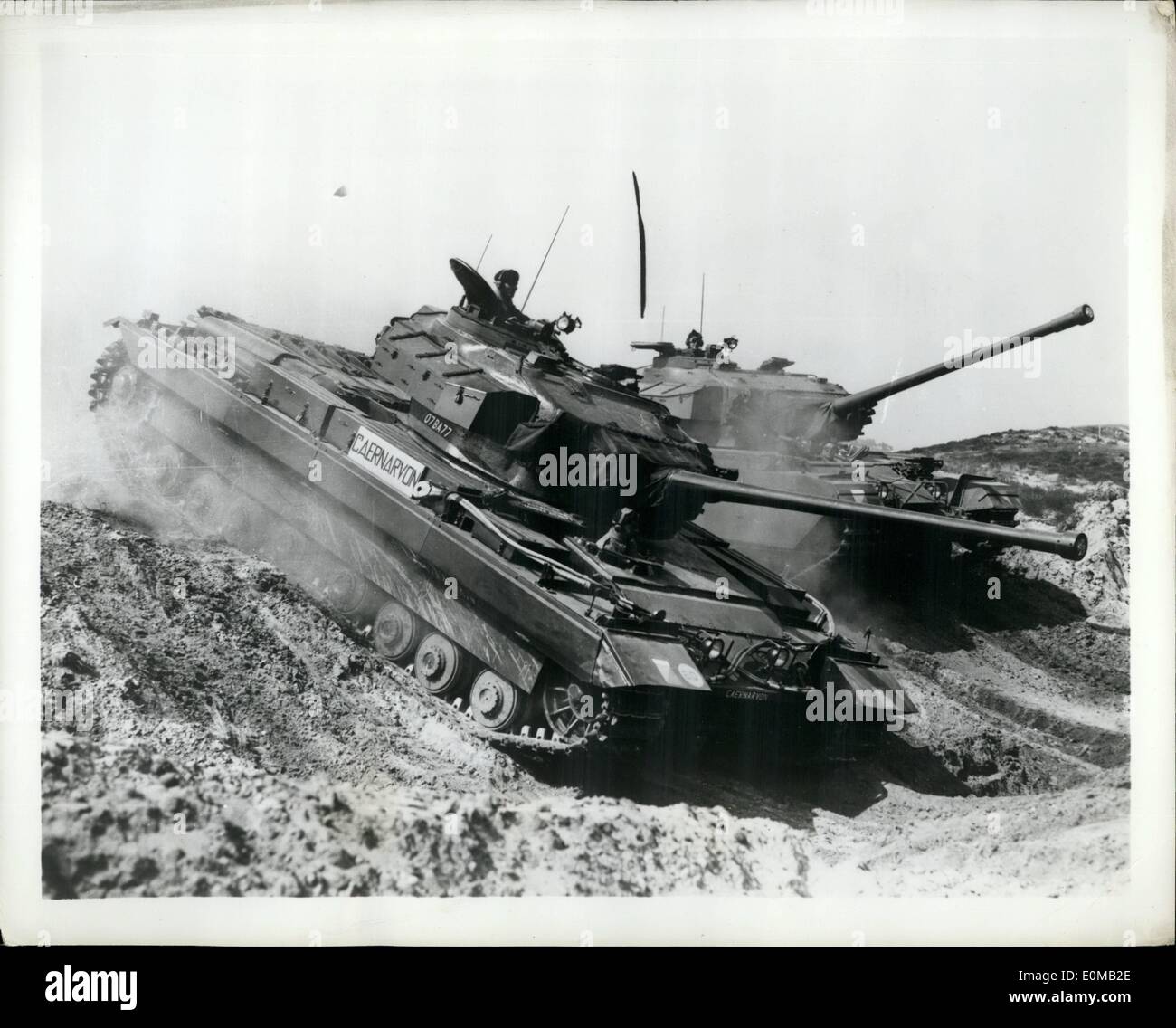 May 05, 1954 - ''Stand-In'' Tank Shows The Way: The Caernarvon, experimental British tank described by Britain's War Minister Antony Head as probably the most powerful in the world, was put through its paces recently at the British Royal Armored Corps Center's annual demonstration of armored fighting vehicles. The Caernarvon has the engine and chassis of the Conqueror, Britain's new super tank, for which it stands in at troop trials pending delivery of the Conqueror. Its turret is that of the Centurion which won high Allied praise in Korea Stock Photo