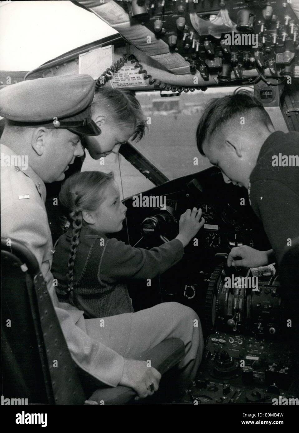 May 15, 1954 - The day for American armed forces was proclaimed the ''day of the open door'' in Frankfurt. An exhibition of different types of airplanes was arranged for German visitors, and children were given free sweets. Pictured: Even here in the cockpit of a C-119 ''Flying Boxcar''(a plane not shown to the public) a small group of guests is allowed to peek around as a German-speaking officer gives them information. Stock Photo