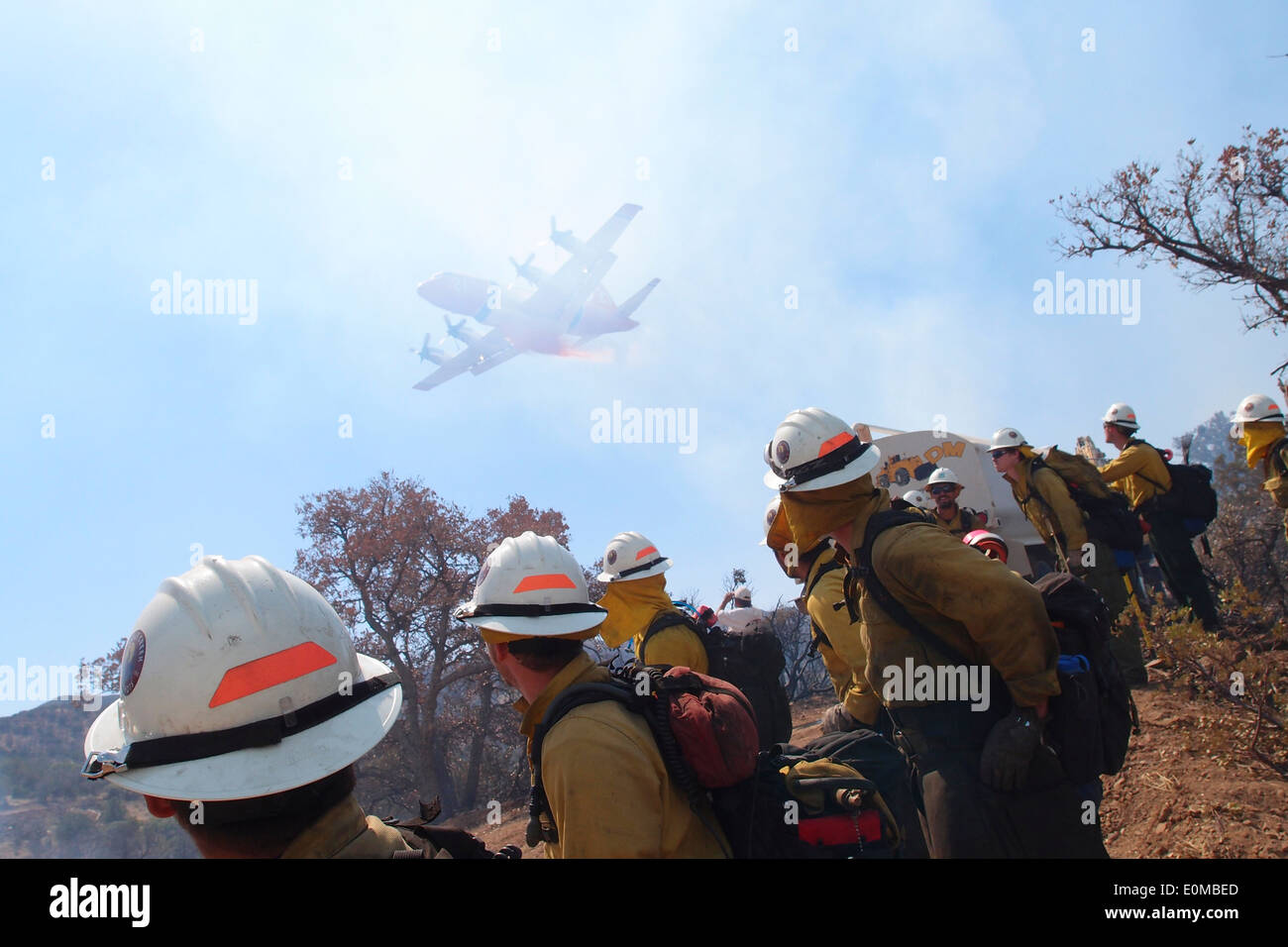 Wolf Creek Hotshot crew stops work to watch as a huge tanker drops a load of retardant on the Wildcat Fire, Nevada, 2011 Stock Photo