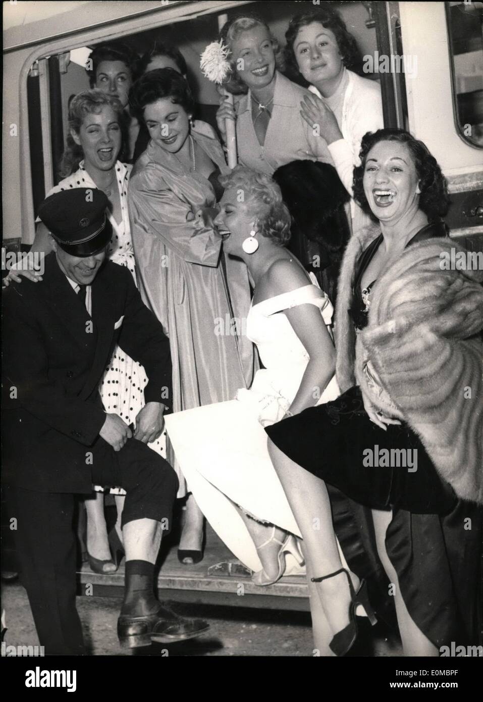 Jun. 06, 1954 - Crooner as bus conductor : Luis Mariano the famous Spanish-french crooner, makes a comparative study of legs - his own and the legs of the starlets he invited to celebrate the ten years of his crooner's career. he also hired an omnibus for the occasion and appeared dis guest  conductor Stock Photo