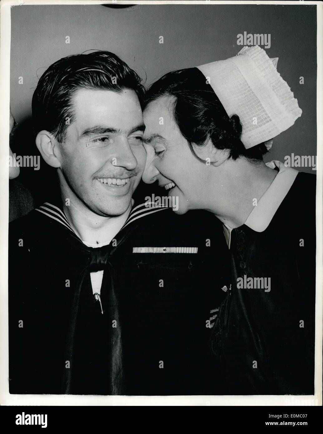 Jun. 06, 1954 - Mother's Kiss For Hero. A kiss from his mother greeted Bosun's Mate, George Banks, 22 year old hero of the recent explosion and fire aboard the U.S. aircraft carrier Bennington, when he landed at Prestwick Airport yesterday for 20 days leave. George was badly burned when he stayed behind in the carrier's pump room to drain fuel onto protected tanks, saving the ship, in which 99 sailors died, and her 2,000 crew from even greater disaster. He joined the U.S. Navy when he emigrated to American two years ago Stock Photo