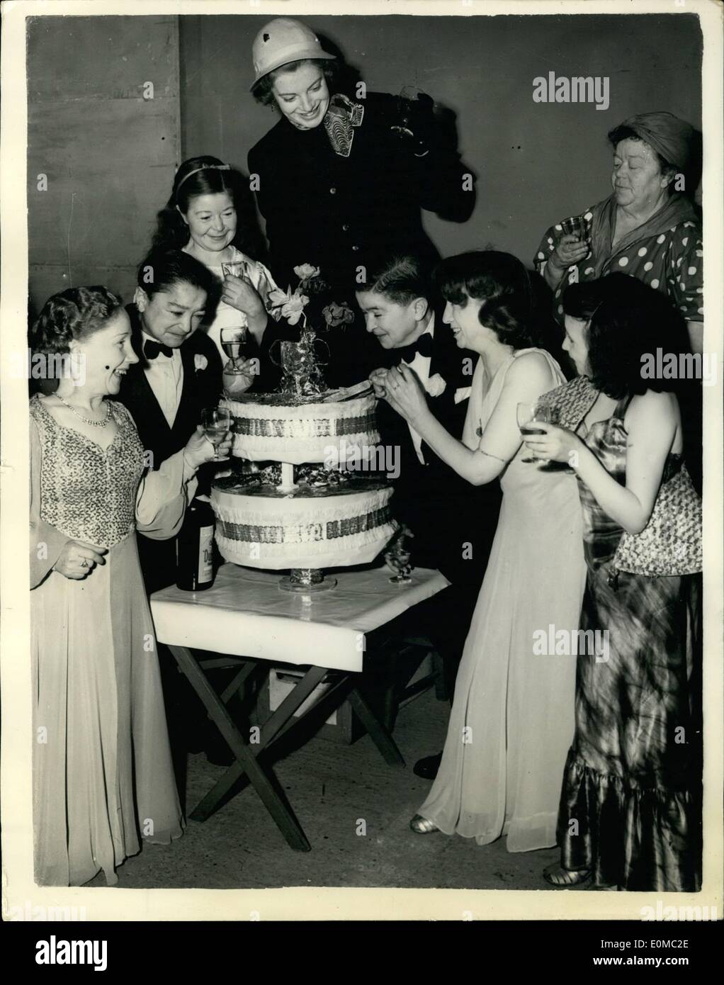 Jun. 06, 1954 - Midgets Celebrate 25th. Wedding Anniversary. Two Midgets, Sonia Frank, aged fifty one and fifty six year old Leonard Frank, known as the Mayor and Mayoress of Midget Town celebrated their 25th. Silver Wedding anniversary in the Fun Fair, at Battersea Festival Gardens. The Best Man and Bridesmaid were also present. Keystone Photo Shows:- The Bride and Bridegroom outing the cake whilst being toasted by the guests. His twin Brother, Simon who was best Man at the wedding is seen on left, as well as Mary Best who was the Bridesmaid Stock Photo