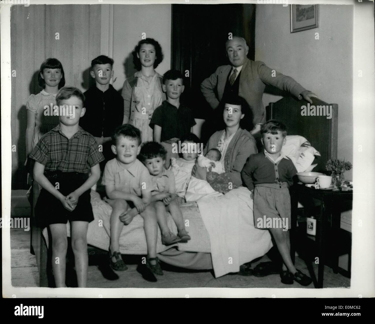 Aug. 08, 1954 - A planned family of ten: Dr. Mervin Seymour Pembrey, and his 40-year-old wife Lottie wanted ten children. And with the arrival of Shirley last Friday - the lucky 13th - the blueprint family, of Great Shelford, Cambridgeshire, was at full strenth. When Shirley arrived the announcement of her birth said the family is now completed as planned ''because'', explained MrsPembrey, ''I did not want other wives to think my husband had been inconsiderate''. Photo shows the Pembrey family. They are from left (back row) Joan, 11, John,12, Maureen,14, Terrence, 10 and Dr. Pembrey Stock Photo