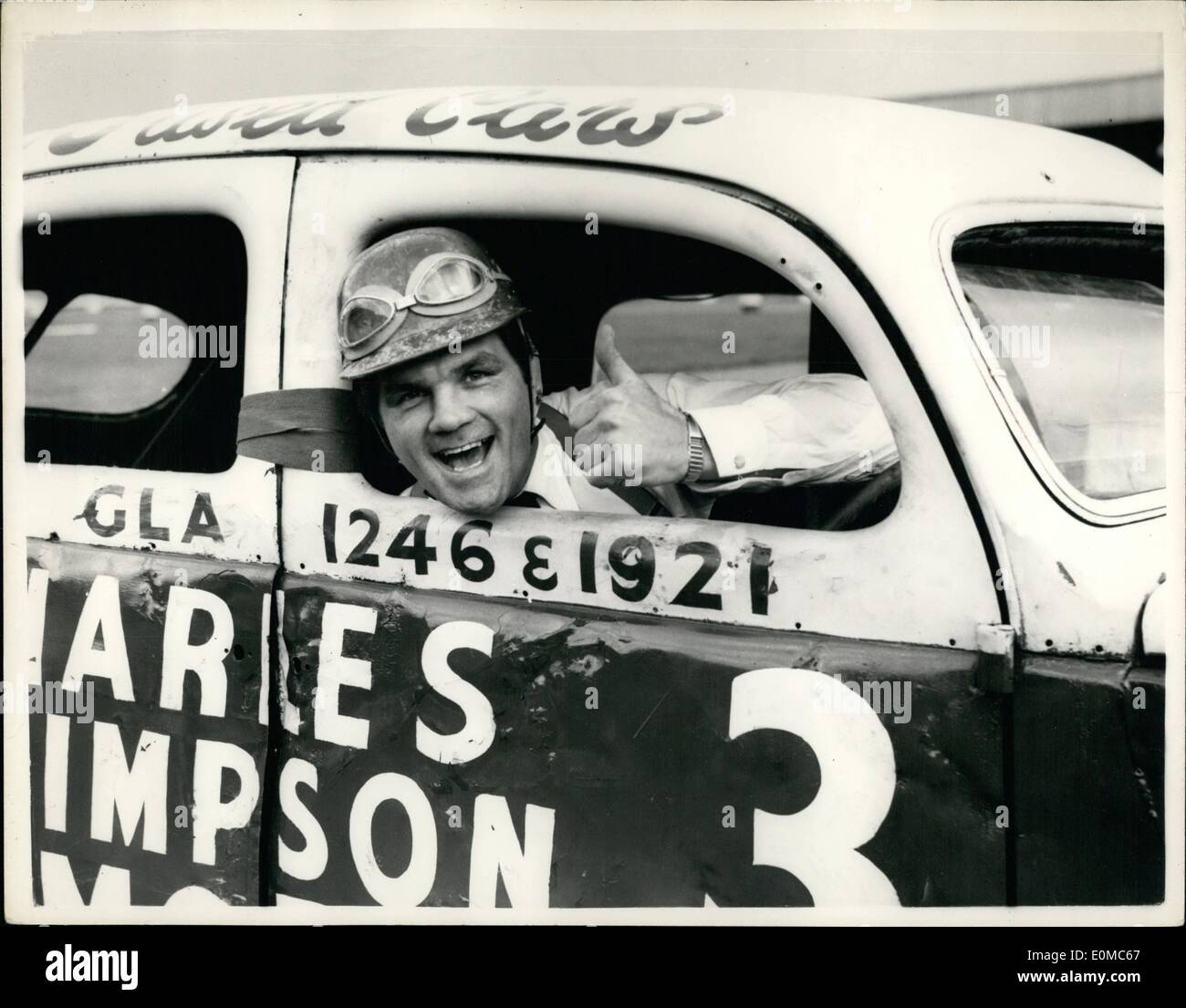 Aug. 08, 1954 - Freddie Mills To Drive In A Stock Car Race For A Bet With Jack Solomons: Jack Solomons has bet Freddie Mills a new suit that he daren't drive in a Stock Car race. To-day Freddie went along th Harringay to get in some practice with a view to taking part in a race next week. Photo shows Freddie Mills wearing a crash-helmet gives the thumbs-up sigh before starting out on a trial run this afternoon. Stock Photo