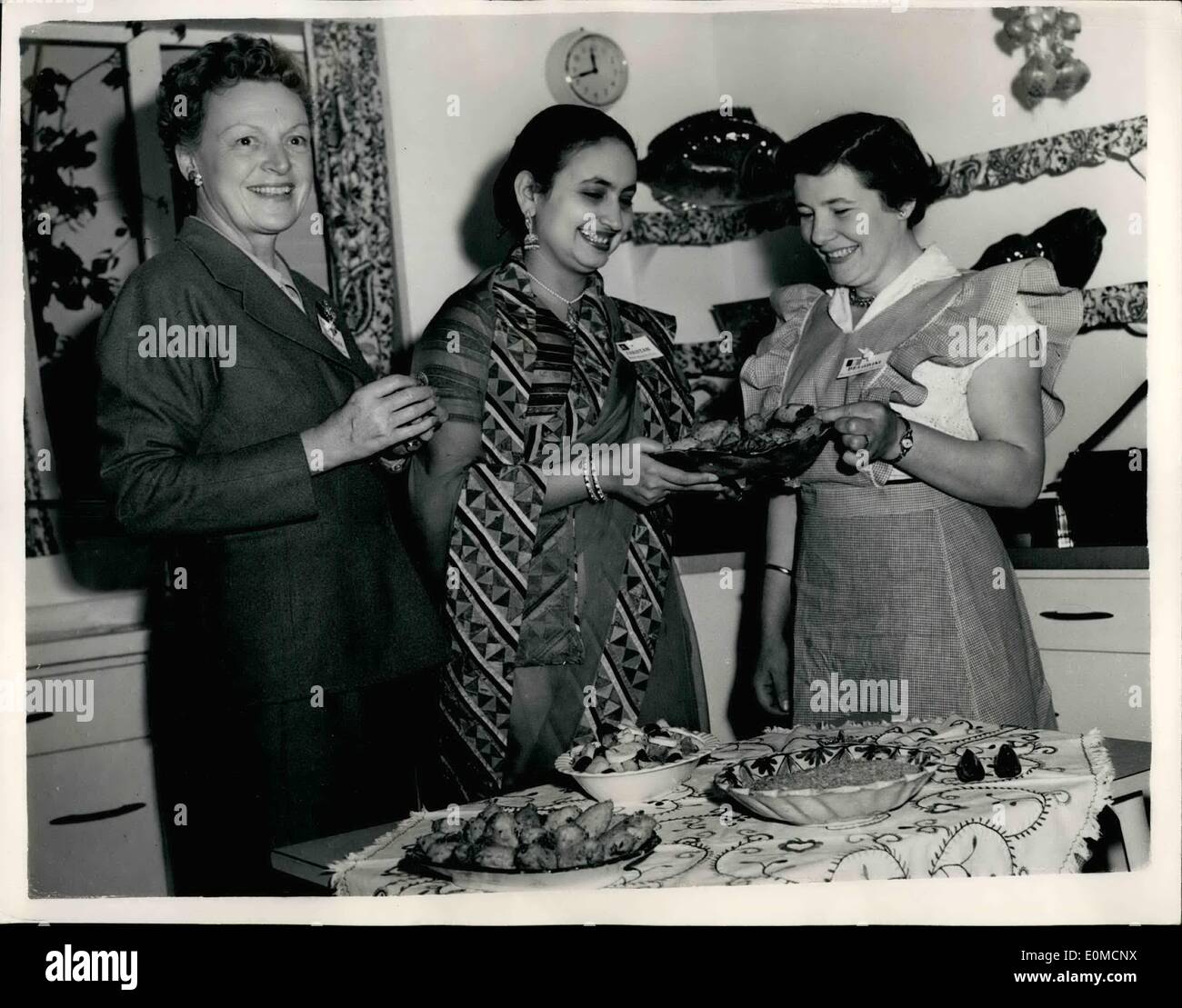 Sep. 02, 1954 - 2-9-54 International Kitchen at the British Food Fair. Today's Press Preview. A press preview for International Kitchen, the Gas Council's exhibit at the British Food Fair at Olympia (Sept 7-18), was held today at Gas Industry House, Grosvenor Place. Eighteen countries including Great Britain will be represented for the exhibition of international cookery. Keystone Photo Shows: Seen in the demonstrating kitchen at today's press preview are (L to R): Mrs. Estrud Bannister, of Copenhagen, Denamrk; Miss Marie-Louise Leceuve, of Mons, Belgium, and Begum Ahmed Ali Khan, of Pakistan Stock Photo