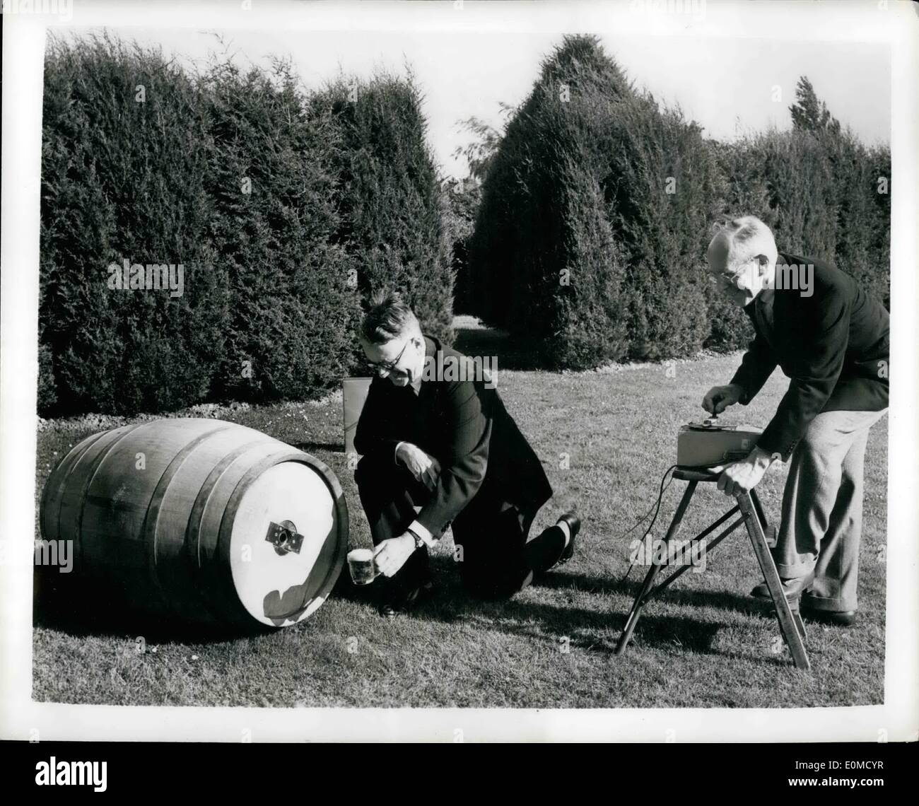 Oct. 10, 1954 - Beer By Remote Control: A beer barrel that rolls around in all directions under radio control was one of the electronic exhibition on the lighter side at a radio show in London. It is a real brewer's barrel containing Guinness stout and a soft drink, either of which can be drawn off and drunk. In addition it holds an electronic motor, batteries., radio receiver and controls. The barrel ha two speeds forward and two backward and can turn left to right. Photo Shows Vice Admiral J.W.S Stock Photo