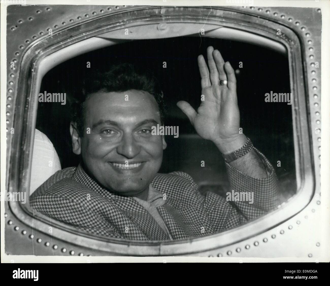 Sep. 09, 1954 - Frankie arrives and is greeted by fans: Crooner arrives from America: Photo shows American Crooner Frankie Laine waves to the crowd of hysterical fans who went to London Airport by coaches to greet him on his arrival from the United States. Stock Photo