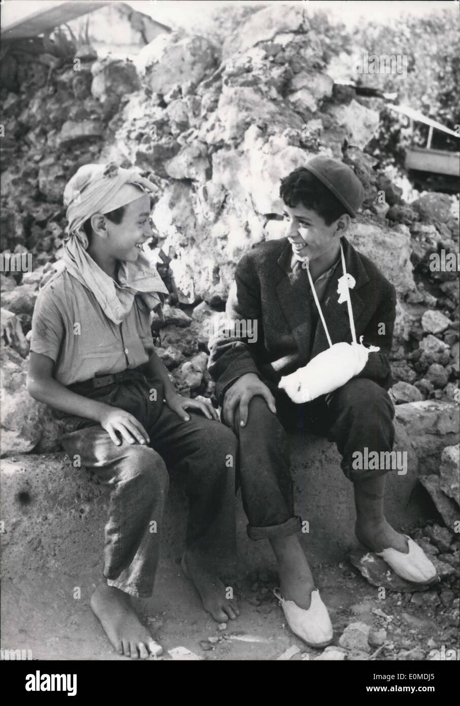 Sep. 12, 1954 - Scenes After The Earth Tremor At Orleansville: Two Young Arab Boys, Survives Of The Earthquake, Smile In The Ruins Of The House. Life Goes On. Stock Photo