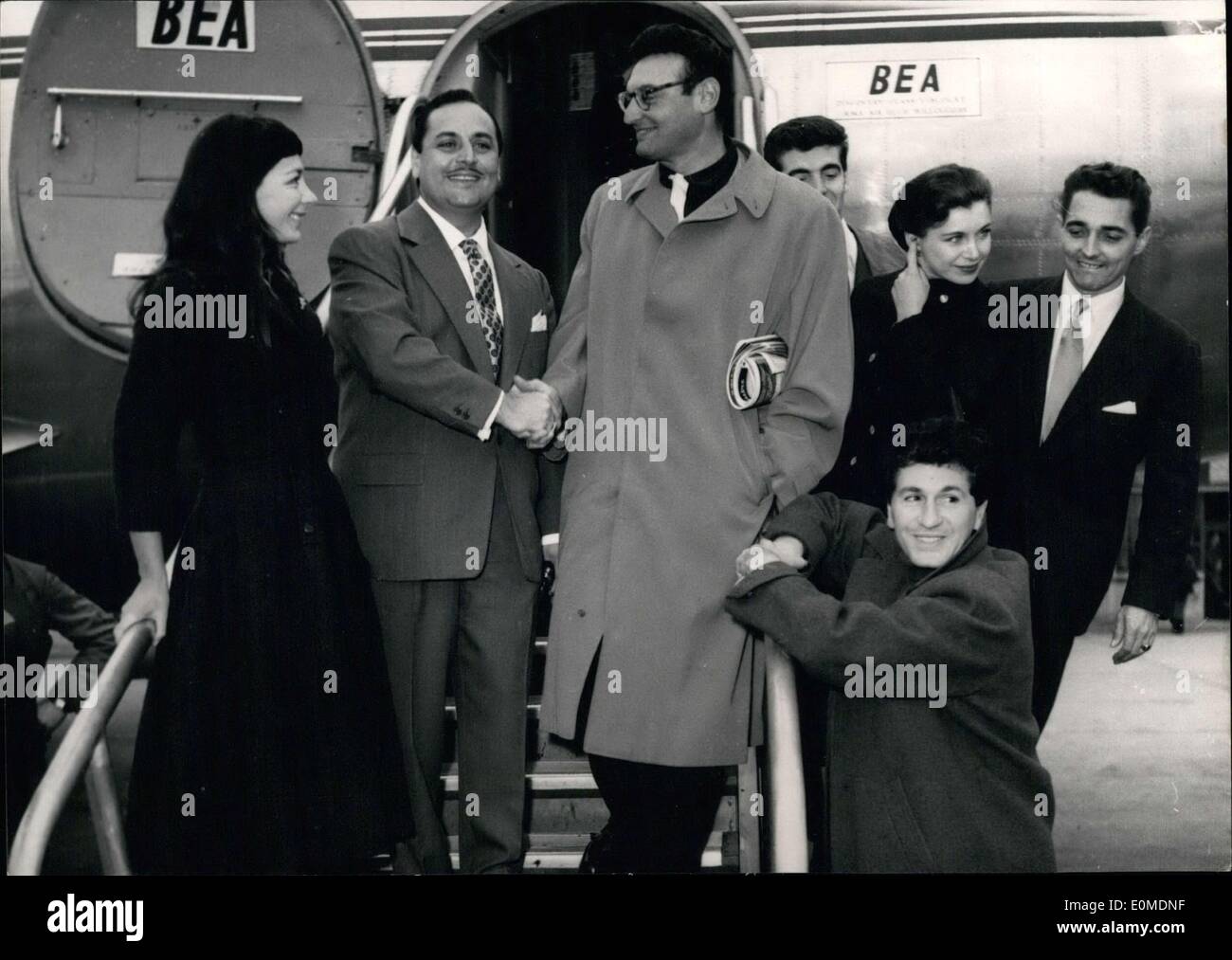 Oct. 15, 1954 - The most well-paid singer in the world Frankie Laine is in Paris for 14 hours. He will be doing two shows at the Alhambra. The artists who created his songs in France welcomed him at the Bourget airport. Hubert Giraud, Annie Rouvre, and Fred Leclair are in the back. Mouloudji is squatting beside the railing. Stock Photo
