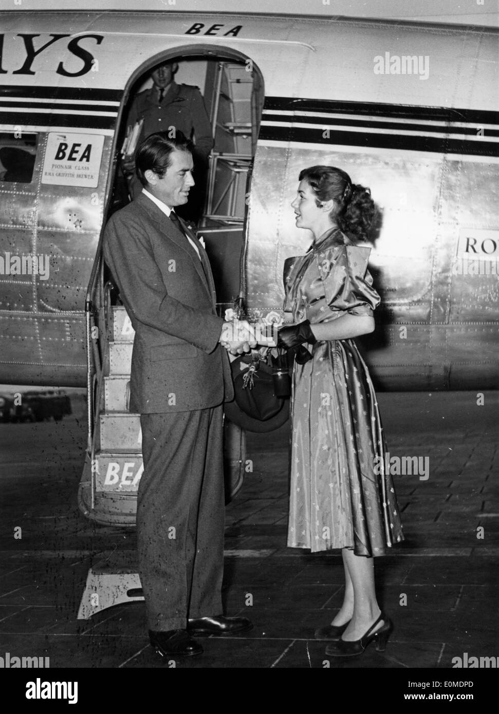 Actor Gregory Peck being greeted by Rita Gan in Berlin Stock Photo