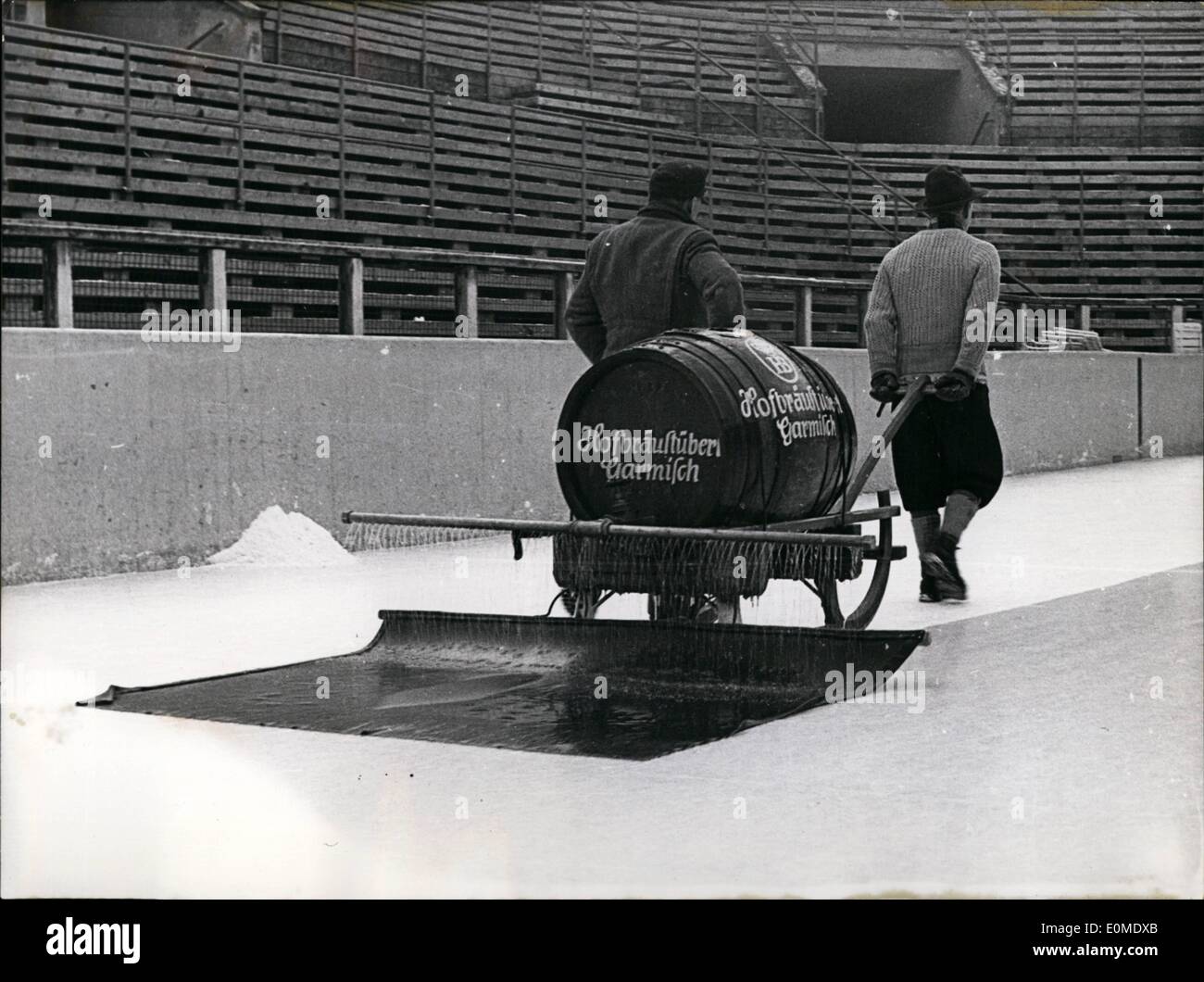 Jan. 01, 1955 - ''In Bavaria one runs on beer..'' jokes one man, newly arrived to the city, as he takes a look at the ice stadium of Garmisch-Partenkirchen. These men are busy ''ironing out'' the course.there is no beer in the barrel, but water. Argentina - People at Cattle Stock Photo