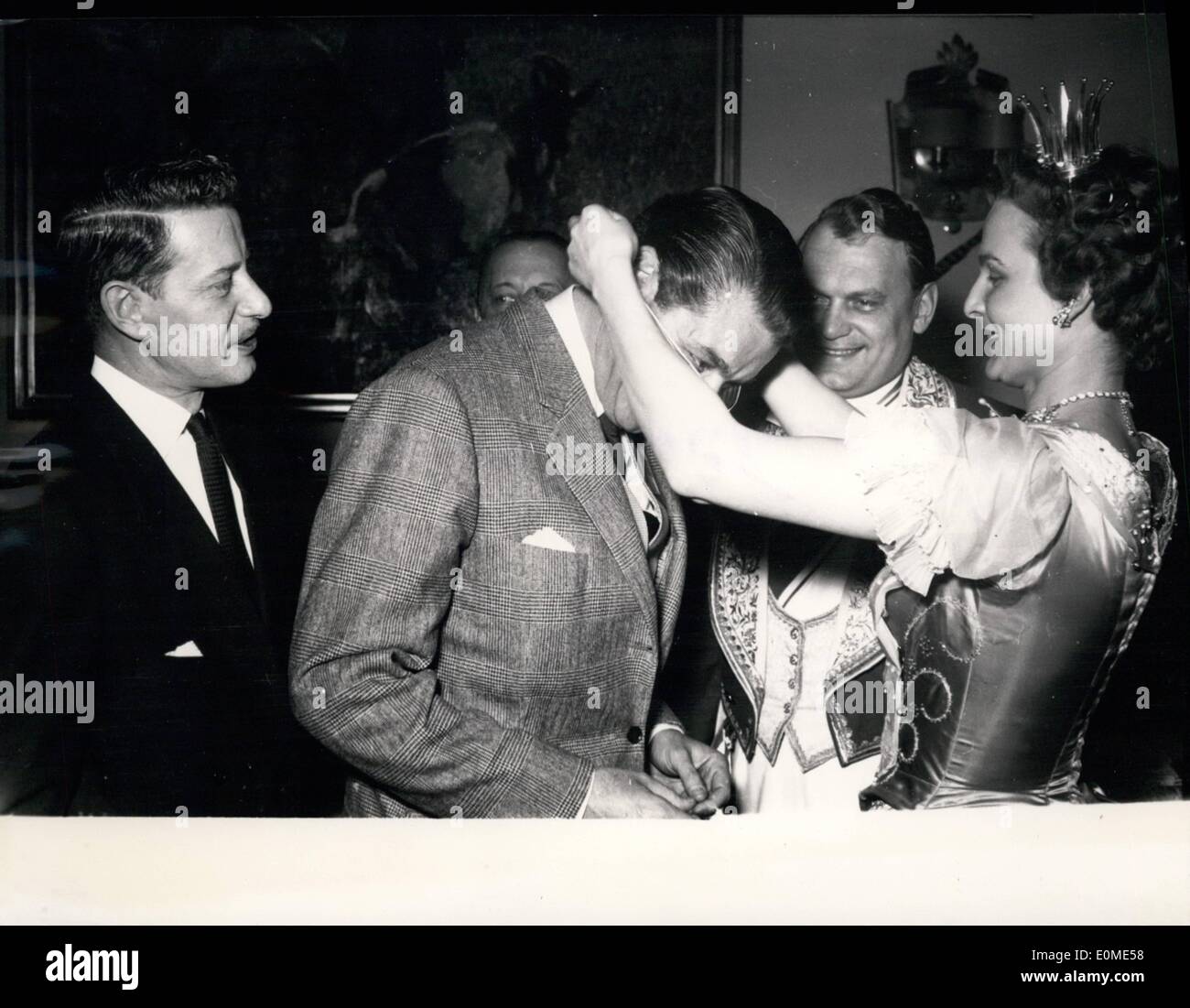 Jan. 01, 1955 - Dieter Borsche and his Co-producer: The famous German film-actor Dieter Borsche (right) met his Egyptian Co-producer Pierre Zarpanely (middle in Munich for discussing the new projects which will begin in April. The Munich Princess of Carnival decorated the foreign guest with an order. Left: Princess of Carnival Helga I. and Prince Carnival Fritz the I. Stock Photo