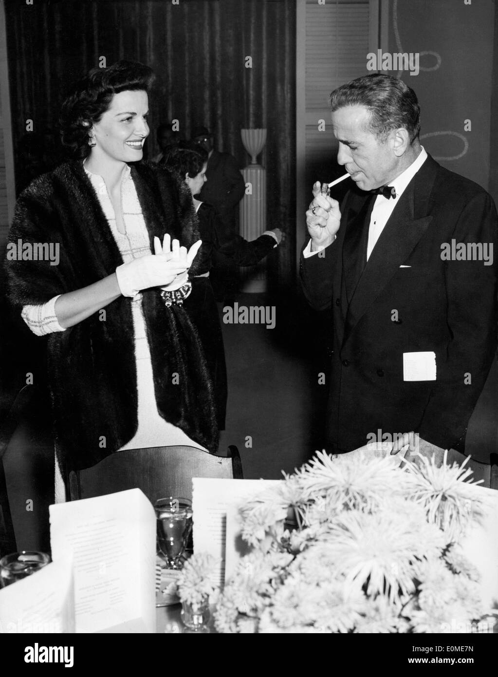 Actress Jane Russell chatting with actor Humphrey Bogart at an event Stock Photo