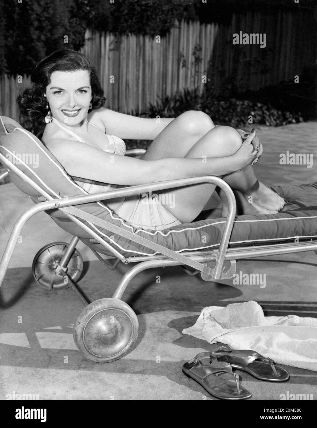 Jane Russell lounging by the pool at home Stock Photo