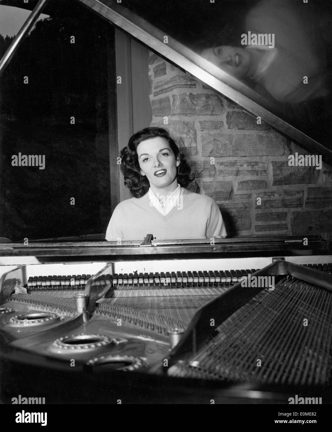 Woman singing playing piano hi-res stock photography and images - Alamy