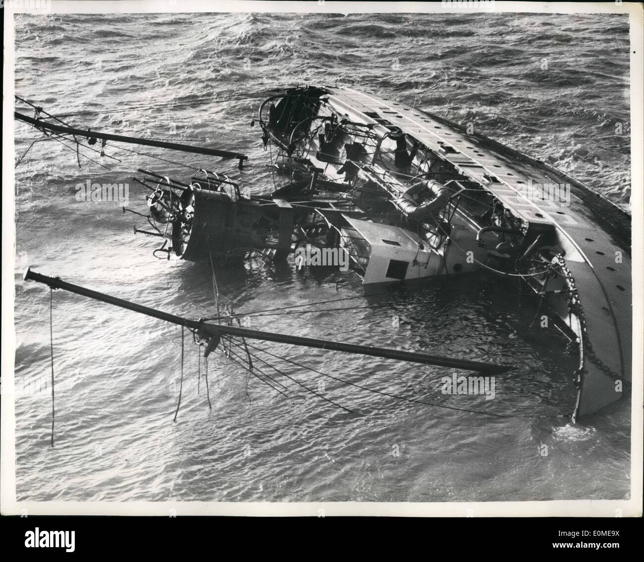 Nov. 11, 1954 - Eight trapped in wrecked Lightship. Man Stands on side of vessel.: Eight men are reported to be trapped in the hull of South Goodwin Lightship wrecked on the Goodwin Sands. One member of the crew was seen standing on the side of the hull - and he was hoisted to safety by a helicopter which flew to the scene. He said the remainder of the crew are trapped below- and the Trinity House vessel Vestral is dashing to the spot with oxy-acetykubg apparatus aboard. Photo shows Aerial view showing the vessel on her side - showing in centre - the man standing on her side. Stock Photo
