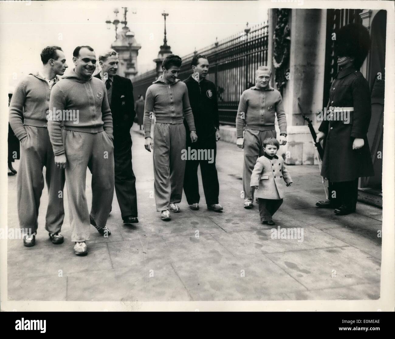 Nov. 11, 1954 - German Footballers out walking in London Strolling past the Palace: Members of the German Football Team that meets England at Wembley on Wednesday - and who arrived in London only this morning - were to be seen out walking and running in the Park - Limbering up etc. Photo Shows Members of the team - wearing their track suits - walking past Buckingham Palace soon after their arrival in London this morning. They are accompanied by 2 1/2 year old Jonathan Gaynor of Edwards Square. Stock Photo
