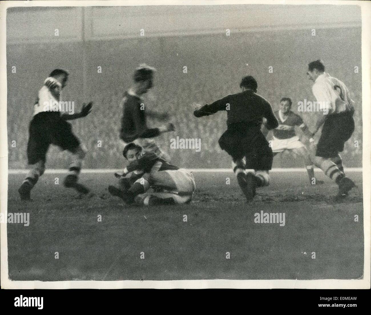 Nov. 11, 1954 - Floodlit football at Highbury. Arsenal v Spartak.: Arsenal this evening played Moscow Spartak in a floodlit match as Highbury. Spartak won 2-1. Photo shows Kelsey, the Arsenal goalie seen saving from an attack by Netto, the Spartak left-half and Paramonov the Spartak inside right. Stock Photo