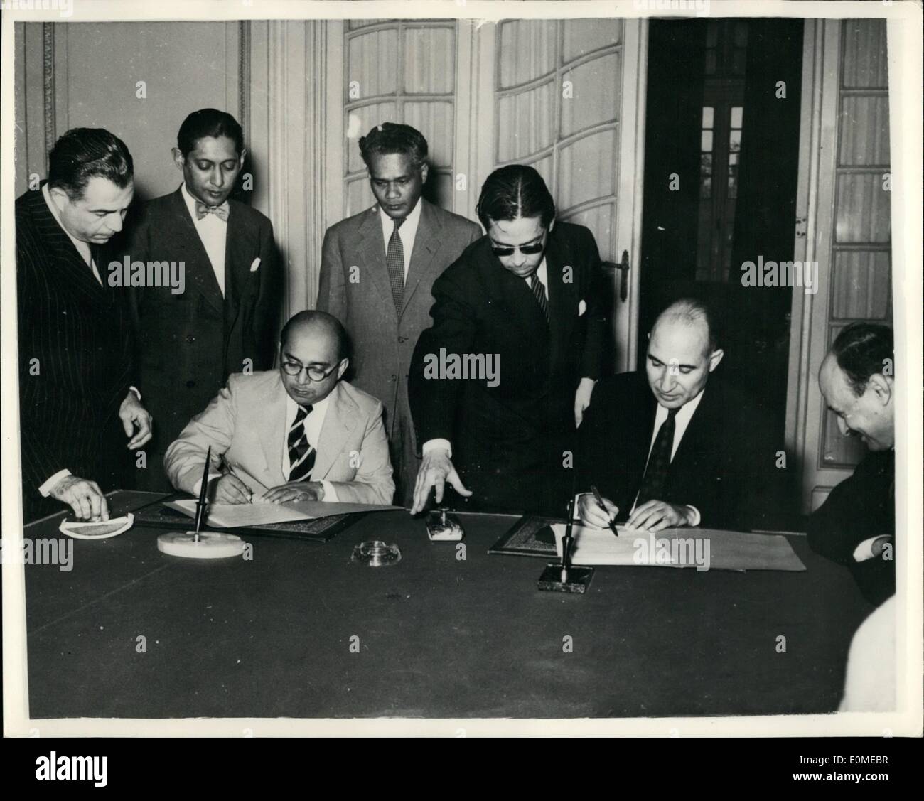 Nov. 11, 1954 - Market for Egyptian cotton textiles pact with Ceylon is signed.: For the first time a trade and payments agreement has been concluded between Egypt and Ceylon. It was signed at the Ministry of Foreign Affaires by Dr. Mahmoud Fawzi, Egyptian Minister of Foreign Affaires on behalf of the Egyptian Government and Shirley Coria, Minister of Commerce, Trade and Fisheries, on behalf of the Government of Ceylon. Photo shows Dr. Mahmoud Fawzi and Mr. Shirley Coria signing the agreement. Stock Photo