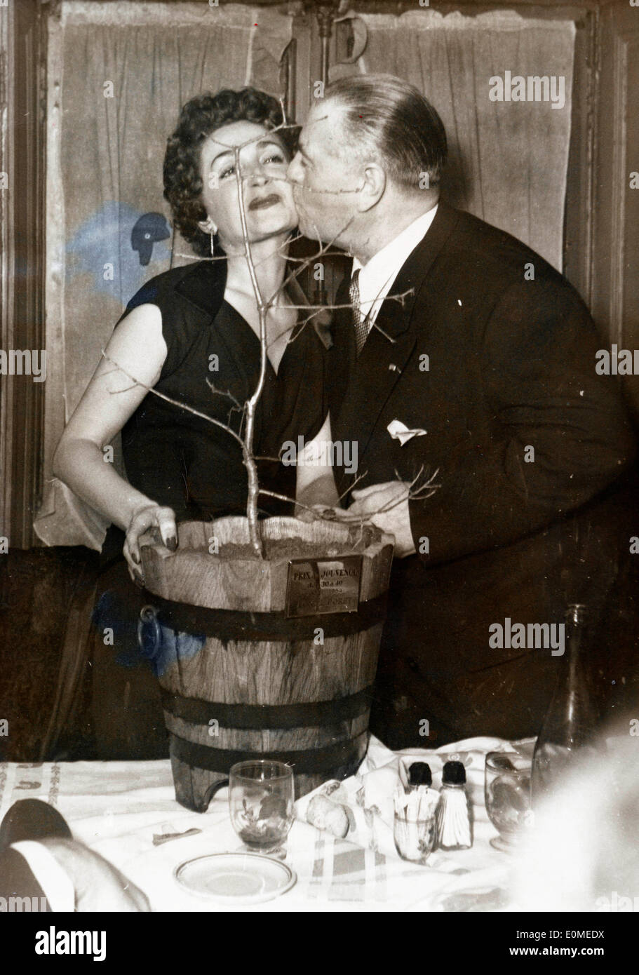 Stunt Pilot Marcel Doret kisses singer Rose Avril at a party Stock Photo