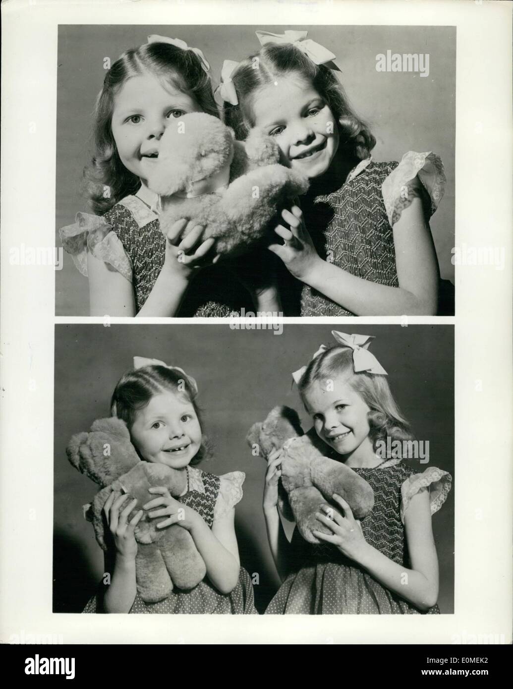 Feb. 02, 1955 - Twins Play Musical Bears - and Ducks: Music boxes in the form of cuddly animals are among toys being shown at this year's British Industries Fair, London and Bermingham, May 2-13. Photo show Top: Seven-year-old twins Judith (left) and Sally Stephens listening to their toy duck and duckling. As it play a tune, the duckling on the back of the duck moves up and down. Bottom: The twinshold to musical bears, one of which can be wound by turning the leg and the other, the head. Manufacturers: The Nedor Co. 2 Hazel Gardens , Edgware, London England. Stock Photo