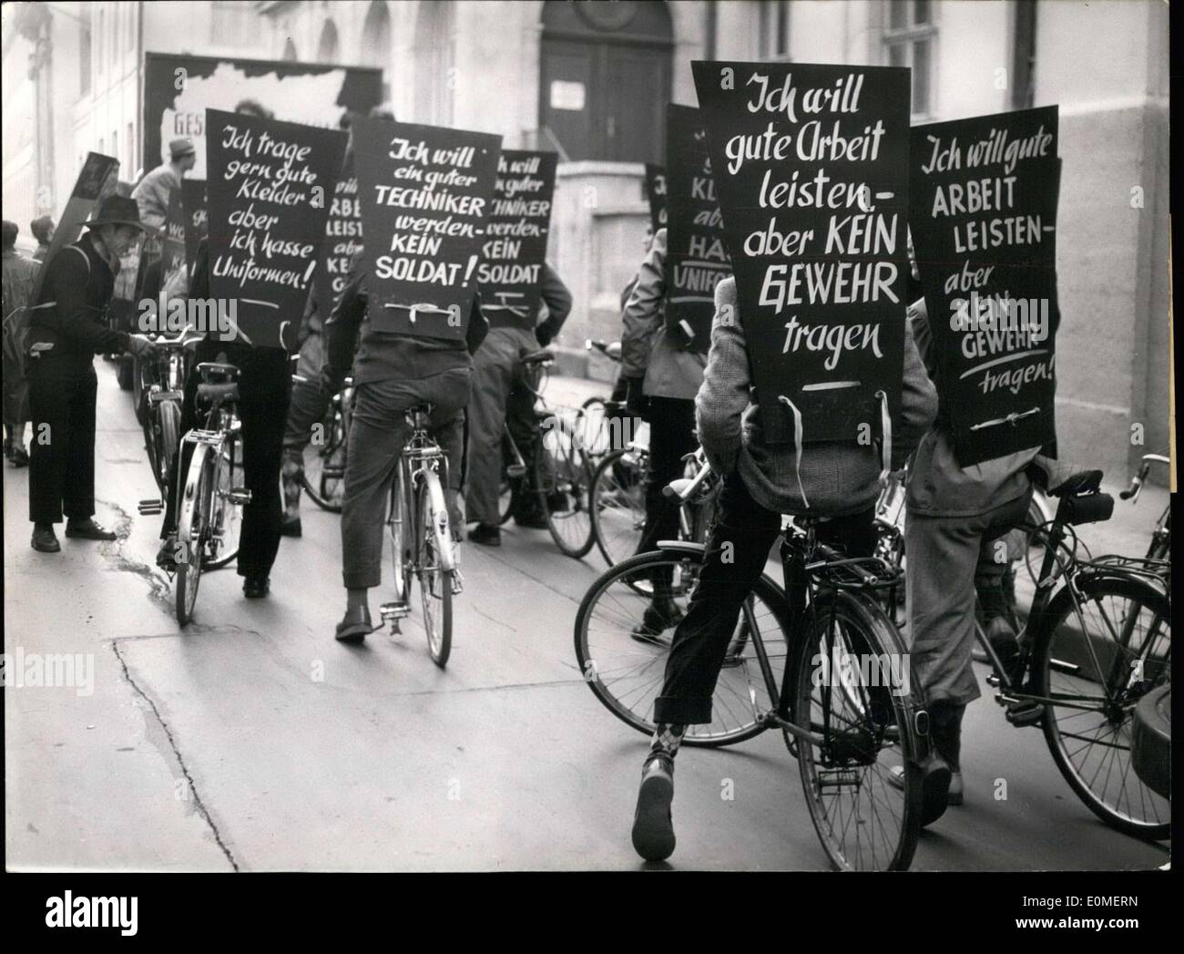 Nov. 20, 1954 - These people are protesting the re-armament of Germany. They carry signs stating their desire to make a living without having to wear a uniform. These protestors rode through the streets of Munich. Stock Photo