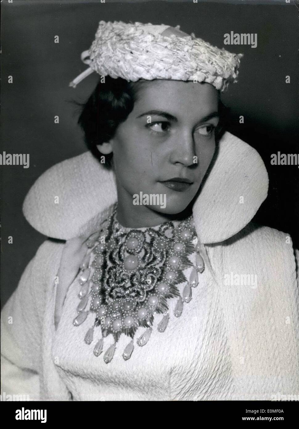 Feb. 02, 1955 - ''Baroque'' Style Makes Come-Back: Fashion Revives ''La Belle Epoque'': Pierre Clarence, The Famous Paris Couturier, Strikes A New-Old Note In Fashion Accessories: Necklace Of White ''Baroque'' Jewels Worn On White Dress With Hat To Match. Stock Photo
