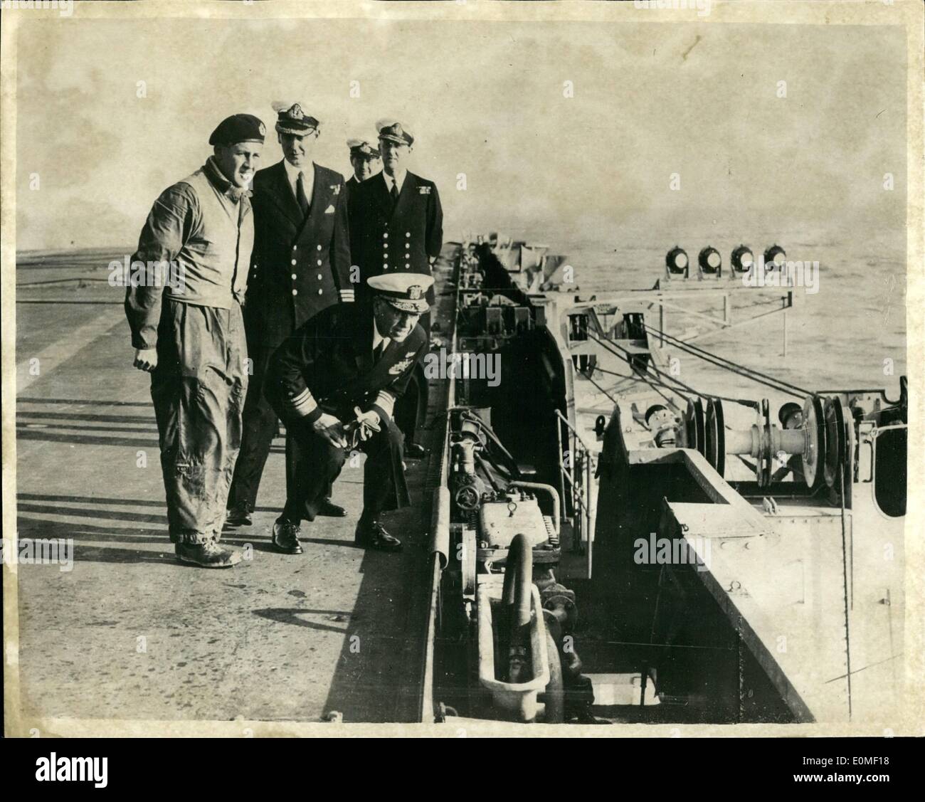 Feb. 02, 1955 - American Admiral sees deck landing aid in H.M.S. Albion. Vice Admiral Thomas S. Coombs, USN, Commander 6th Fleet in H.M.S. Albion inspecting the mirror landing aid, the device developed by the Royal Navy to reduce the risk of accidents while deck landing. Admiral Coombs went aboard by Helicopter during the combined British - U.S. Naval exercises in the Eastern Mediterranean. Also in the Picture are Lieut. Commander W.G. Cook (In flying kit); Commander P.C. Whitefield Obe; R.N.; Rear Admiral A.R. Pedder R.G. (Flag Office Aircraft Carriers) and Lieut. Commander S.F. Berthon R.N. Stock Photo