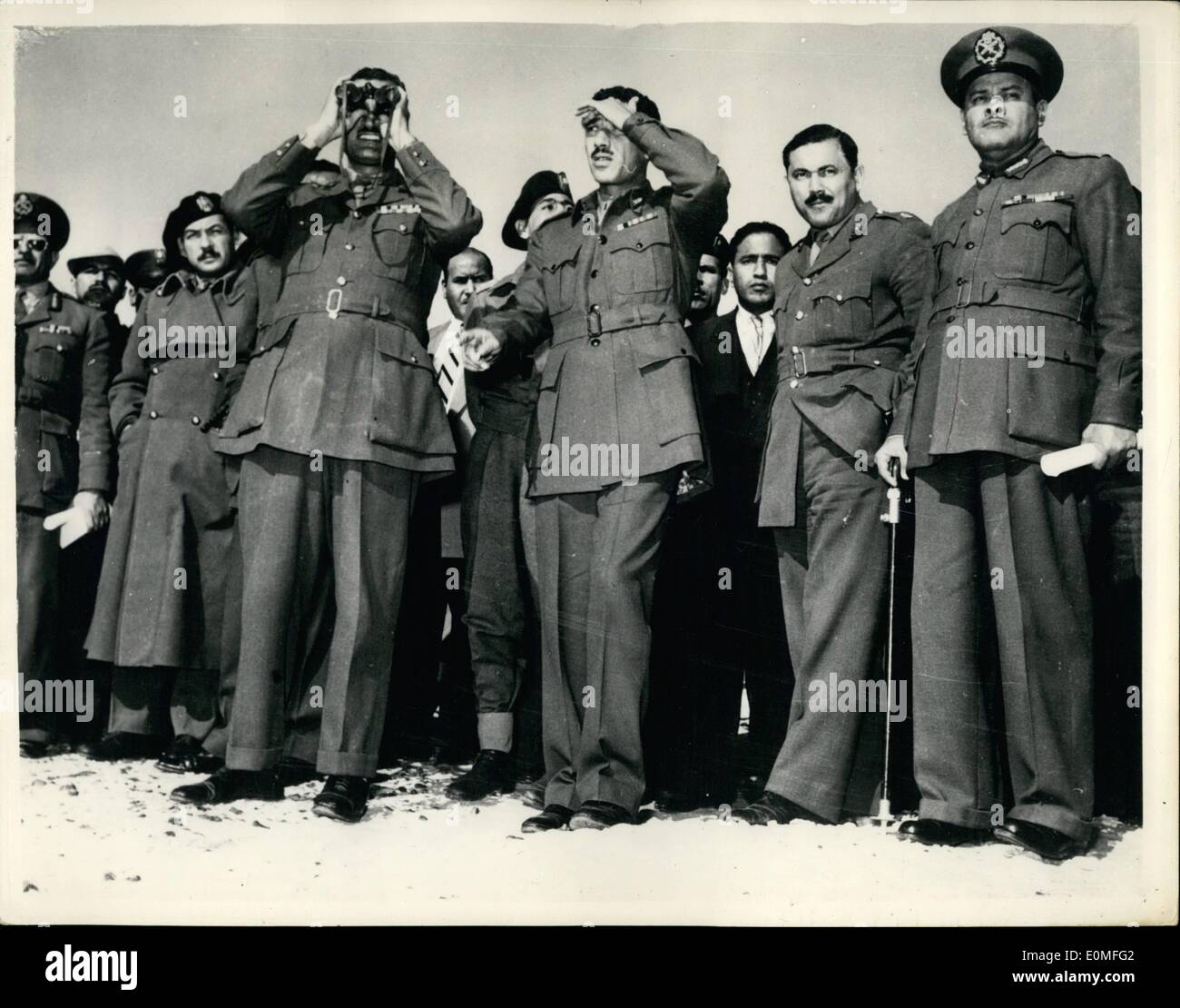 Dec. 12, 1954 - Prime Minister of Egypt attends Desert Manoeuvres. Nasser uses field glasses.: Prime Minister Gamal Abdul Nasser and several members of the Revolutionary Command Council attended the annual Armed Forces Manoeuvres in the desert west of Cairo. Photo shows: P.M. Nasser, members of the Revolutionary Council and Cabinet Ministers seen as they watch the manoeuvres. Stock Photo