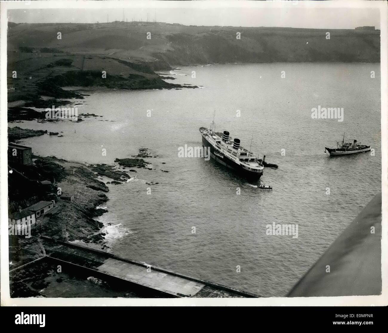Mar. 03, 1955 - Norwegian Liner Aground off Plymouth Hoe as seen from the air: The scene from the air - of the Norwegian liner ''Venus'' as she lay on the rocks - almost on top of the famous Plymouth Hoe. Twice yesterday - tugs tried to refloat the 6,269 ton vessel...Five thousand people watched as tugs tried again last night - the liner lifted - but remained fast on the rocks.. Heavy gear and cargo is being removed in an effort to give her a better chance of being refloated at the next high tide. Stock Photo