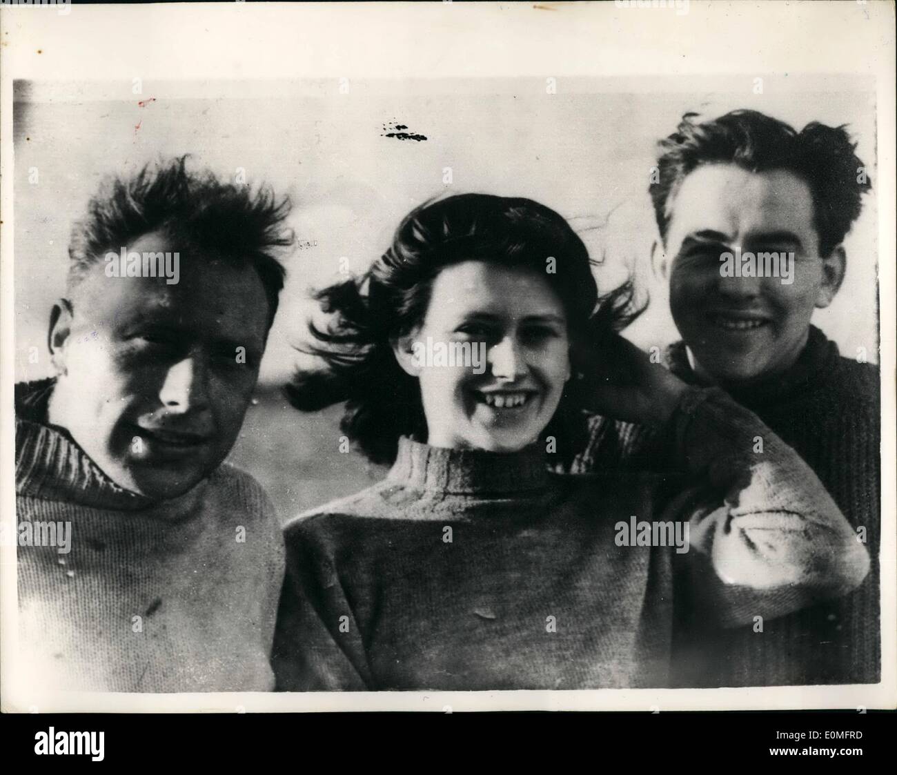 Mar. 03, 1955 - Three saved from sinking plane. Two men and a woman were saved from a sinking plane in a North Sea rescue last night. They were rescued by the Thames tanker, adaptivity, in heavy seas off Clacton - On sea. They were Mr. Leslie Anderson, Miss Sheila Martin and Mr. John Eadon who were returning in an Auster plane from a week-and in Paris, when they ran into bad weather, the tanker as he could. Photo shows Seen on board the Adaptivity, today are the three rescued week -and fliers - who in borrowed seaman's jerseys and dungarees, Mr. Leslie Anderson, Miss Sheila Martin and Mr Stock Photo