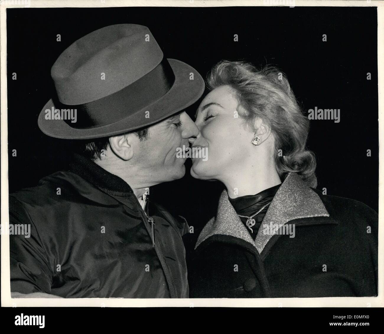 Jan. 01, 1955 - Television's ''Kissing Boy'' arrives from Hollywood. He has a kiss for Hildegarde: Ron Randell - who took over for a short time from Eamon Andrews ad Chairman of Television's '''What's My Line'' and two created quite a sensation by kissing Barbara Kelly and other participants during the programme arrived at London Airport from Hollywood this afternoon. He was met by Swiss Actress Hildegarde Christian who is to appear in ''Rosalinda''. Ron Randell is being  for who accuses him of ''Mistreatment, failure to support her and desertion since November 1953 Stock Photo