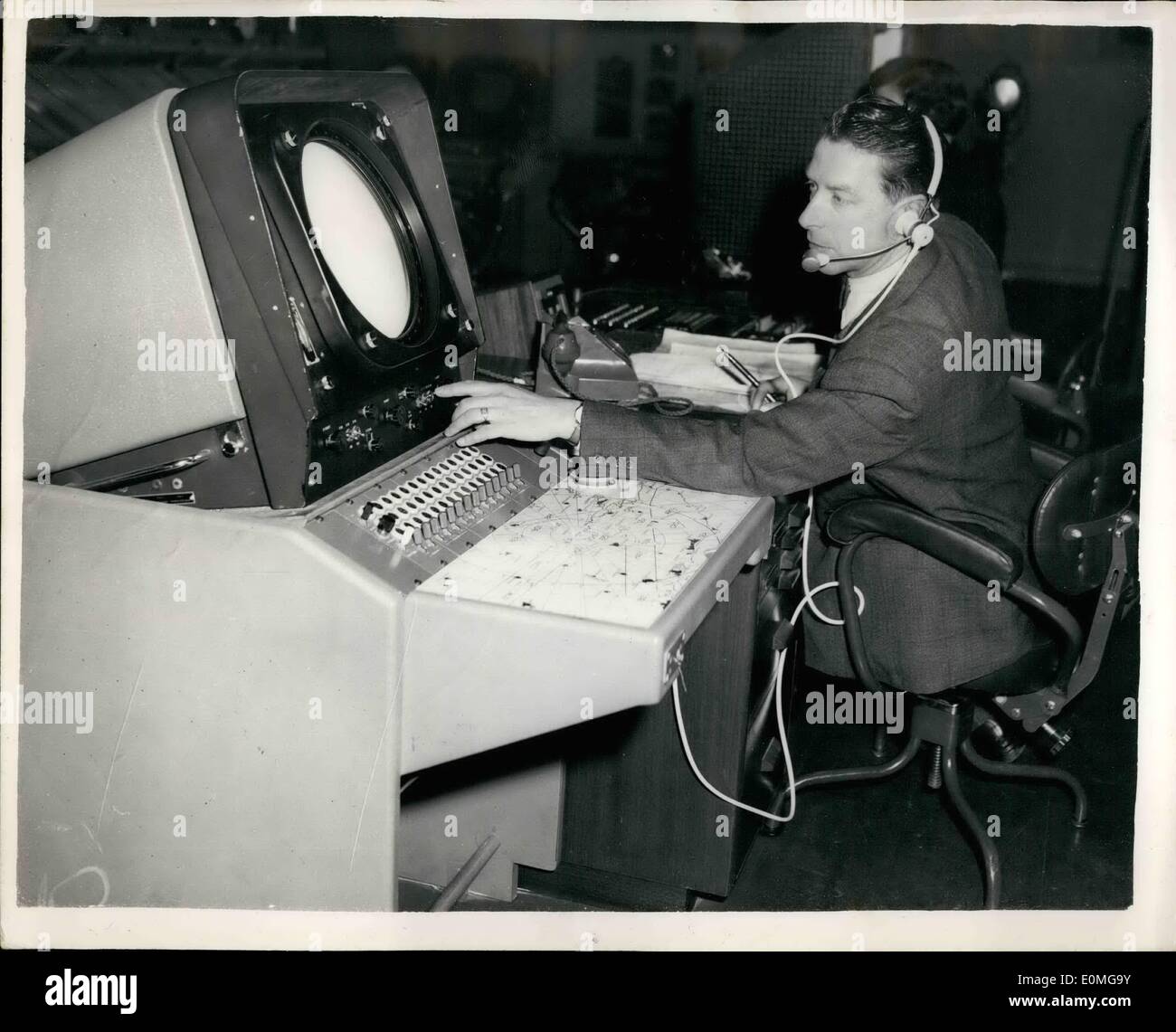 Mar. 18, 1955 - 18-3-55 Press visit to New Southern Air Traffic Control Centre at London Airport. A press visit was held today at London Airport to the new Southern Air Traffic Control Centre which is to replace the existing centre at Uxbridge. It contains airways and radar control to supervise the Civil Aviation for the whole of Southern England. It has been specially designed to cope with the ever increasing traffic to airports in the London area. Keystone Photo Shows: The Supervisor of the new Control Room, Mr. F.G. Henson M.B.E., checking the general air traffic situation. Stock Photo