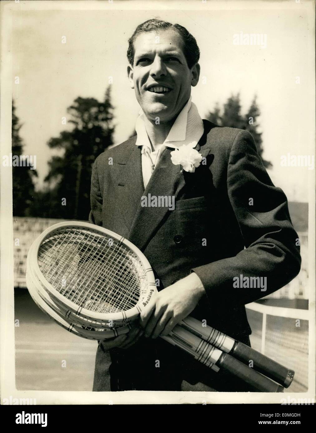 Apr. 25, 1955 - British Hard Courts Lawn Tennis Championships... Tony Mottram Becomes A ''Daddy''............ The British Hard Courts Lawn Tennis Championships opened at Bournemouth today.......... Photo Shows Tony Mottram sports a button hole -- after winning his match with Geoffrey Piercy of Survey at Bournemouth today....... Tony's wife Joy gave birth to a 9 Lb baby boy at 3 a.m. this morning.... They celebrated the birth by Winning his match 6-0; 6-1; 6-2. Stock Photo