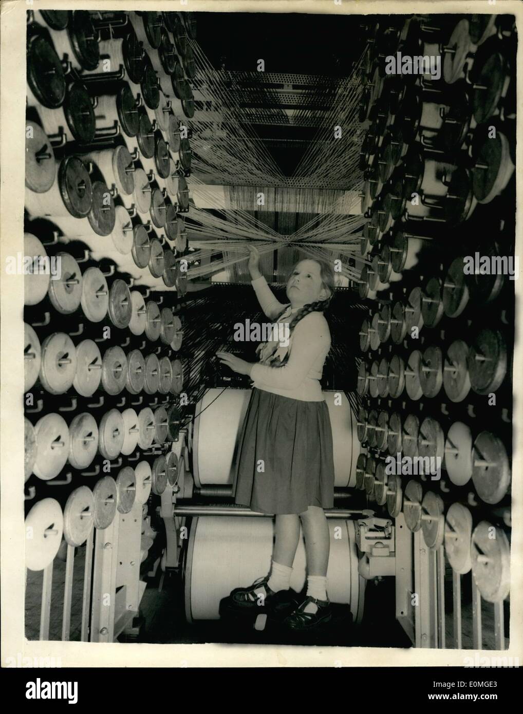 Apr. 29, 1955 - 29-4-55 Preview of the British Industries Fair at Birmingham. Photo Shows: 9-year-old Dione Grice, of Birmingham, finds the interior of an Axminster carpet loom, which is on show, rather interesting of bewildering. Stock Photo