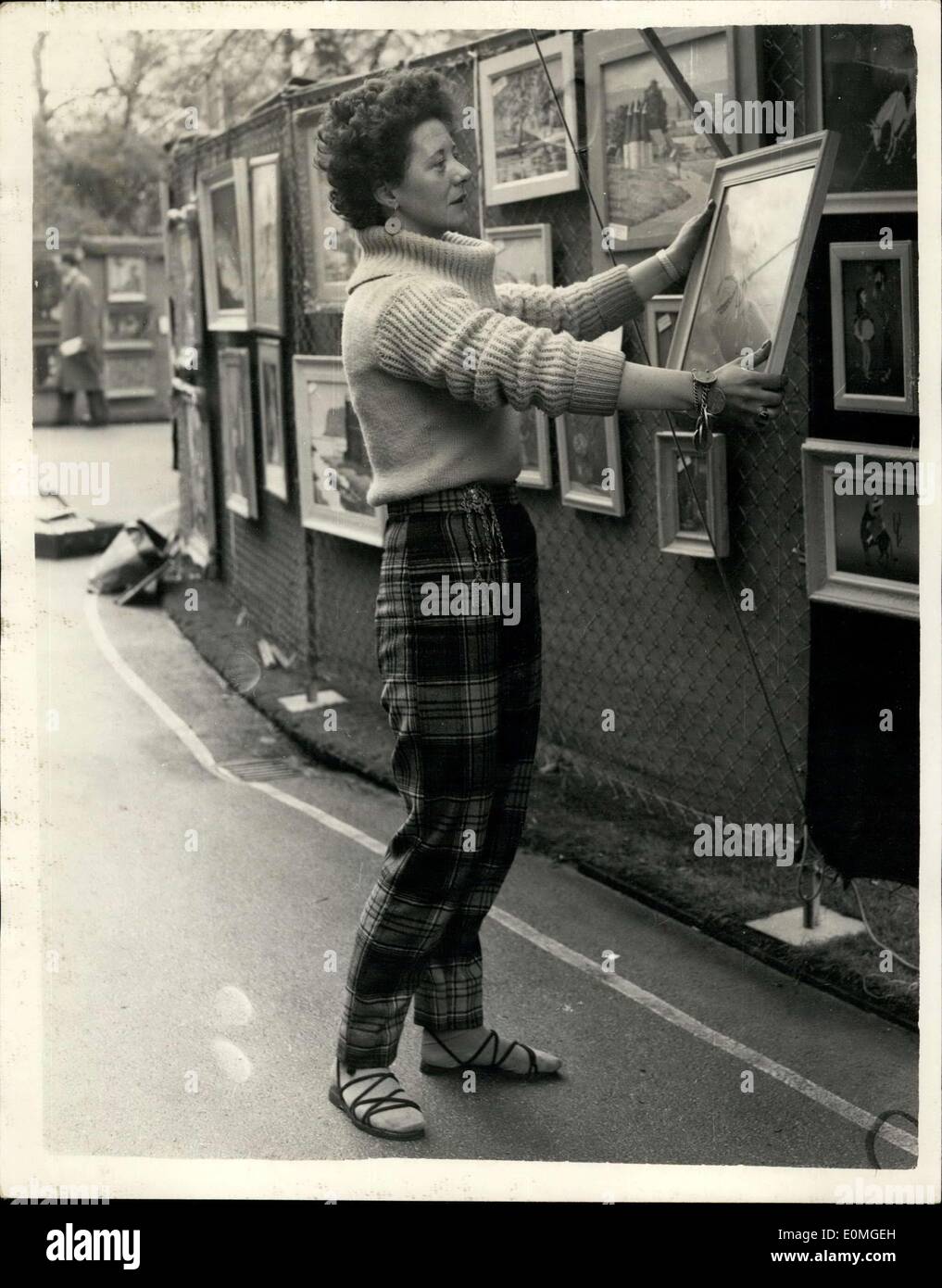 May 02, 1955 - London County Council Open Air art show Exhibitor with Tartan Trews. Photo shows Miss Margaret Holden (29) of Brixton - wears tartan trews as she hangs one of her exhibits at the London county Council open Air art show which opened at the Embankment Gardens this morning. Stock Photo