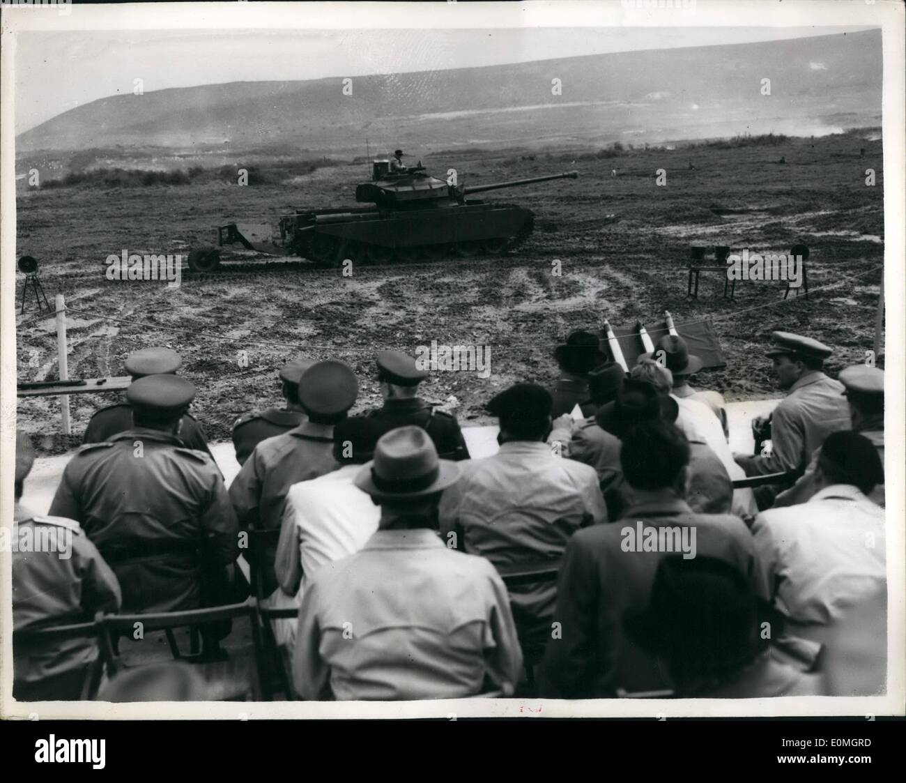 May 05, 1955 - European Defence delegates on visit to Lulworth Centurion tank with Detachable fuel trailer.. Delegates of the European Defence Community - including Herr Dr. (Formerly Lieut, Gen) Speidel of Germany - paid a visit to R.A.F range at Lulworth. Photo Shows General view as delegates watch a demonstration of a Centurion tank- with a detachable Mono-Baseline trailer, for carrying extra fuel.. It is armour plated, gives the tank a much longer range and can be dropped off the case, and not impair the machine's efficiency. Stock Photo